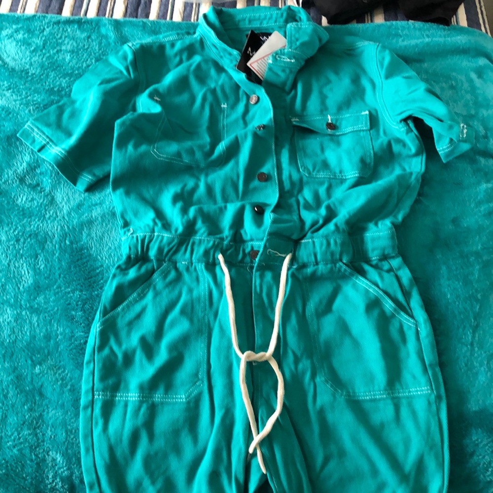 man’s green jumper, button down drawstring waist with white stitching.